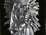 a close up of a silver statue of a woman holding a child