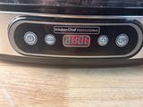 a close up of a toaster on a wooden table