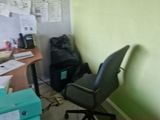 a desk with a chair and a computer on it