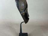 a close up of a sculpture of a person ' s head on a stand