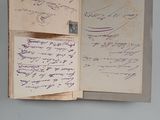 an open book with writing on it sitting on a table