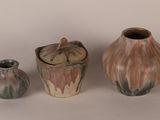 three different vases sitting next to each other on a table