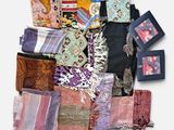 many different types of scarves laid out on a white surface