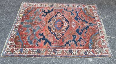 an oriental rug on the ground with a red and blue design