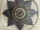 a silver and gold medal with a star on it