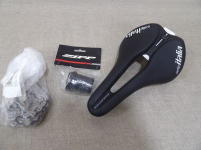 une selle de vélo et un sac posé par terre