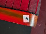 a sticker on the tail light of a red car