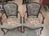 two chairs that are sitting next to each other in a room