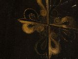 painting of a cross on a black background with a gold design