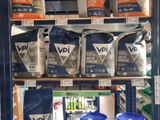 a shelf full of various types of paint in a store