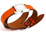 an orange leather watch band with a silver buckle on a white background