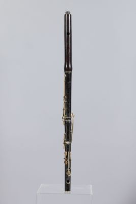 a close up of a black and gold pen on a clear stand