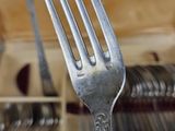 a fork in the middle of a pile of silverware