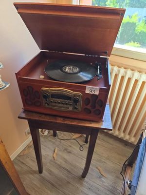 a record player sitting on top of a wooden table