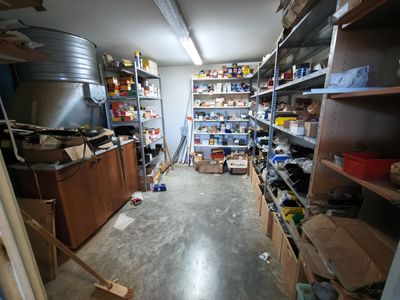a room filled with lots of shelves and shelves filled with items