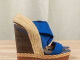 blue and brown wedged sandal with wooden platform on wooden table