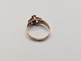 a close up of a gold ring on a white surface
