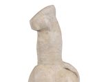 a small statue of a giraffe sitting on a white surface