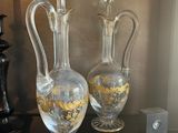 two glass vases sitting on a black table