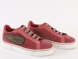 a pair of pink sneakers with wings on the side