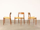 three wooden chairs with yellow upholstered seats in a room