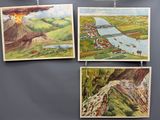 paintings hanging on the wall of a restaurant with a view of a river