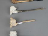 four different types of pipe smokings are lined up on a gray surface