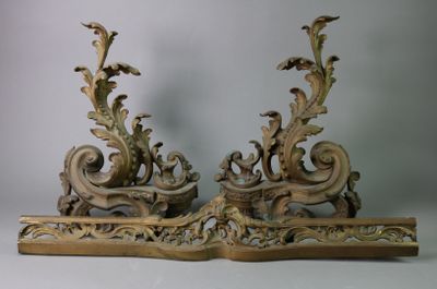 a pair of ornate wooden sculptures on a white surface