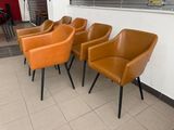 four chairs that are sitting in a row on the floor