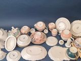 many different types of porcelain dishes and bowls on the table
