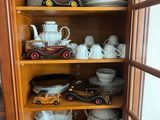 a wooden cabinet with a lot of plates and cups on it
