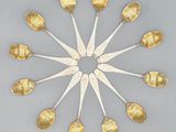 a lot of spoons arranged in a circle on a table
