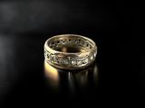 a close up of a gold ring on a black surface