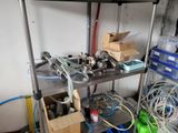 a metal shelf with various tools on it in a room