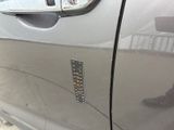 a close up of a car door handle with a sticker on it