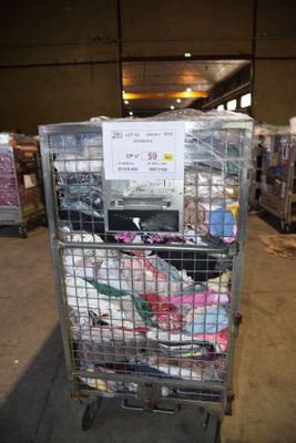 a cart with a lot of items in it in a warehouse