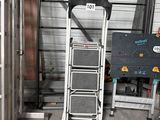 a picture of a ladder in a garage next to a sign