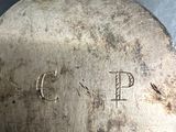 a metal object with writing on it sitting on a table