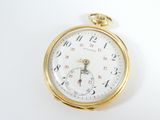 a close up of a pocket watch on a white surface