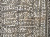 a white and black rug with a pattern on it