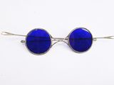 pair of blue tinted glasses on a white background