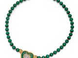 a green and gold necklace with a heart shaped pendant