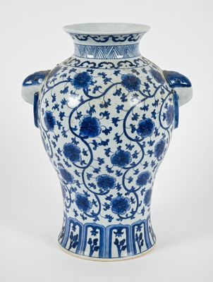 a blue and white vase with blue flowers on it