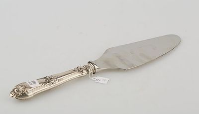 an antique silver plated cake knife with a silver handle