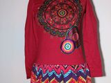 a picture of a colorful dress on a mannequin stand