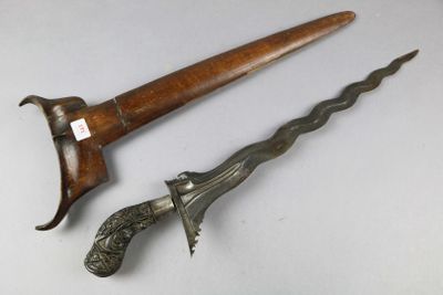 pair of antique wooden and metal daggers on a white surface