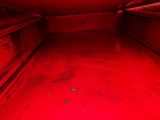 a red light shining on the floor of a room