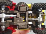 a person holding a toy car made out of legos