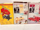 three boxes of toys that are sitting on a table
