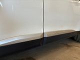 a white car that has been painted white and has a flat tire